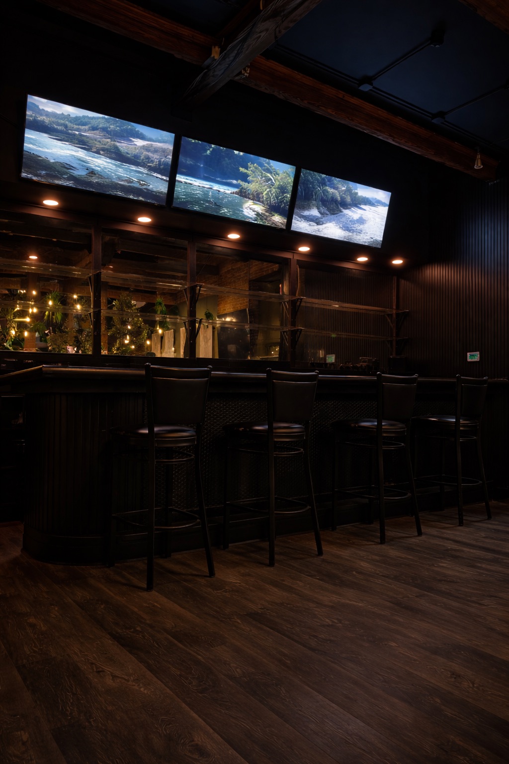 Bar with TVs above and dark wood stools