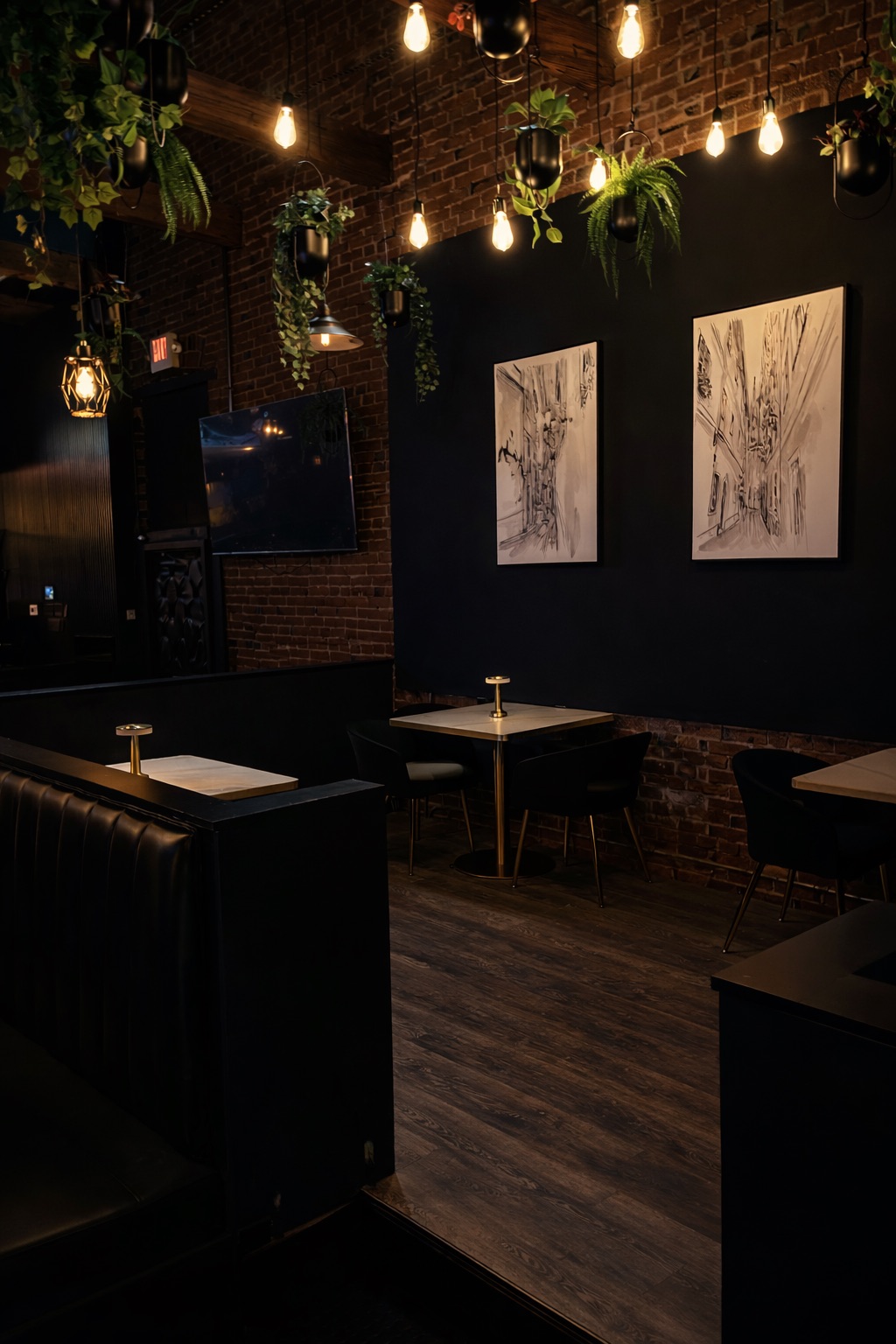 Booth with framed sketches on charcoal wall